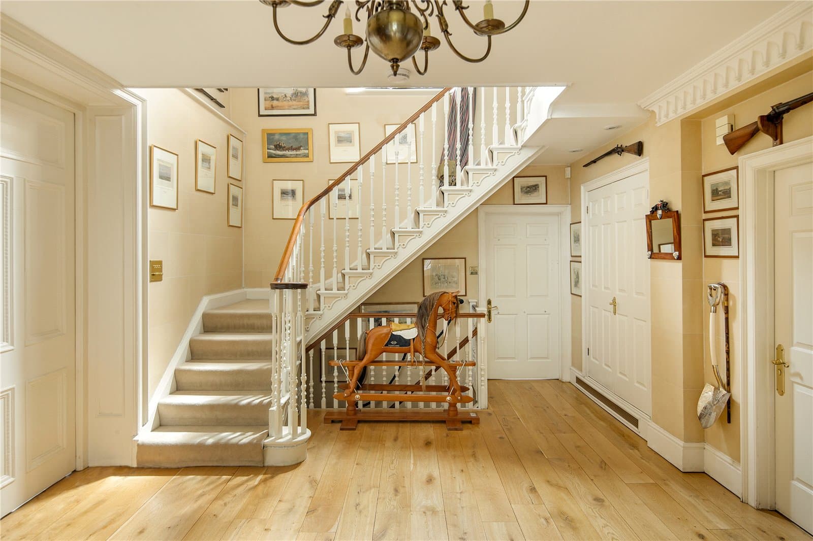 Grand entrance hall at Highwood Lodge, Highwood Hill, London with staircase, timber flooring and period detailing