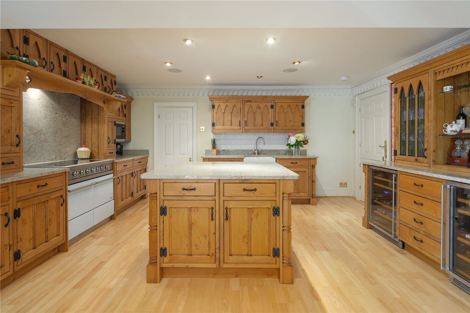 Spacious country style kitchen at Highwood Lodge, Highwood Hill, London with central island and fitted cabinetry
