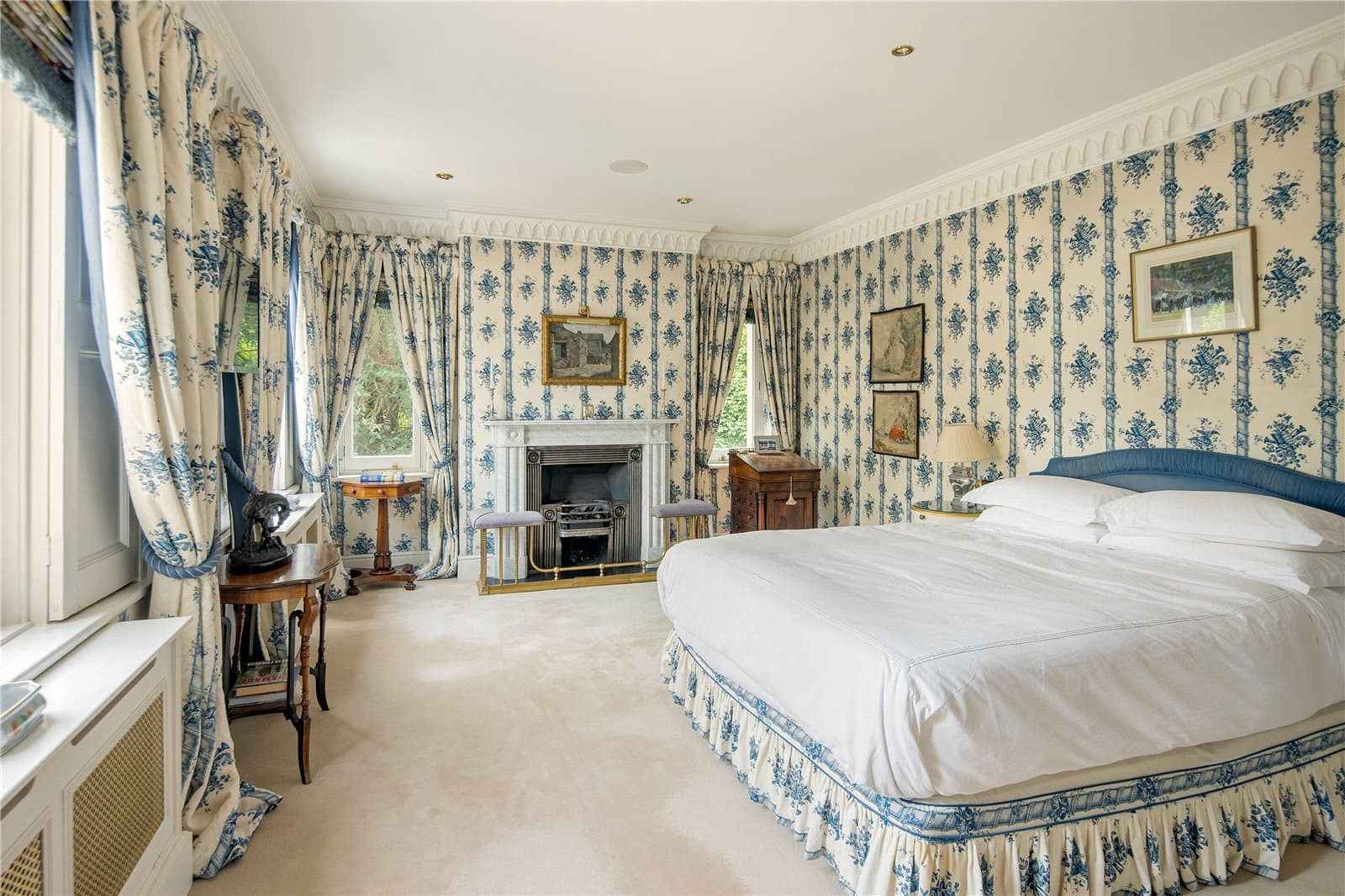 Light filled bedroom at Highwood Lodge, Highwood Hill, London with fireplace and garden views