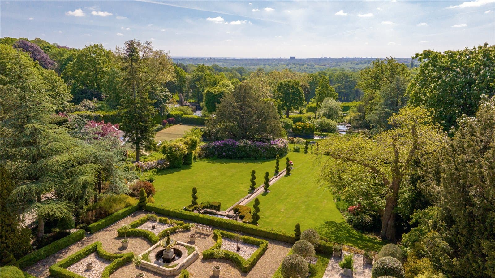 Landscaped gardens and grounds at Highwood Lodge, Highwood Hill, London with formal terraces and countryside outlook