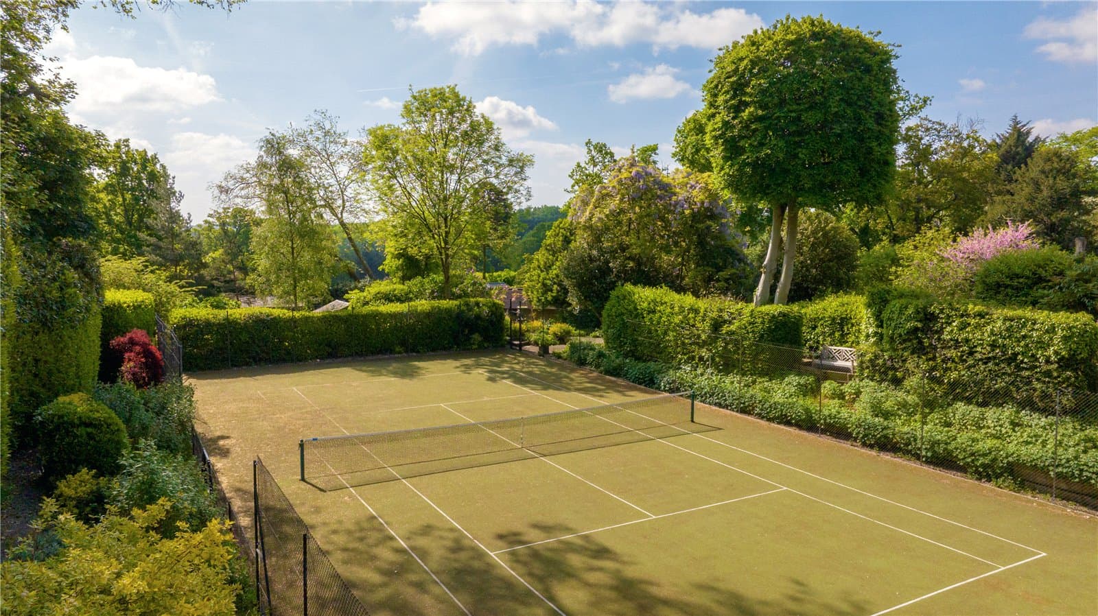 Private tennis court within the landscaped grounds of Highwood Lodge, Highwood Hill, London